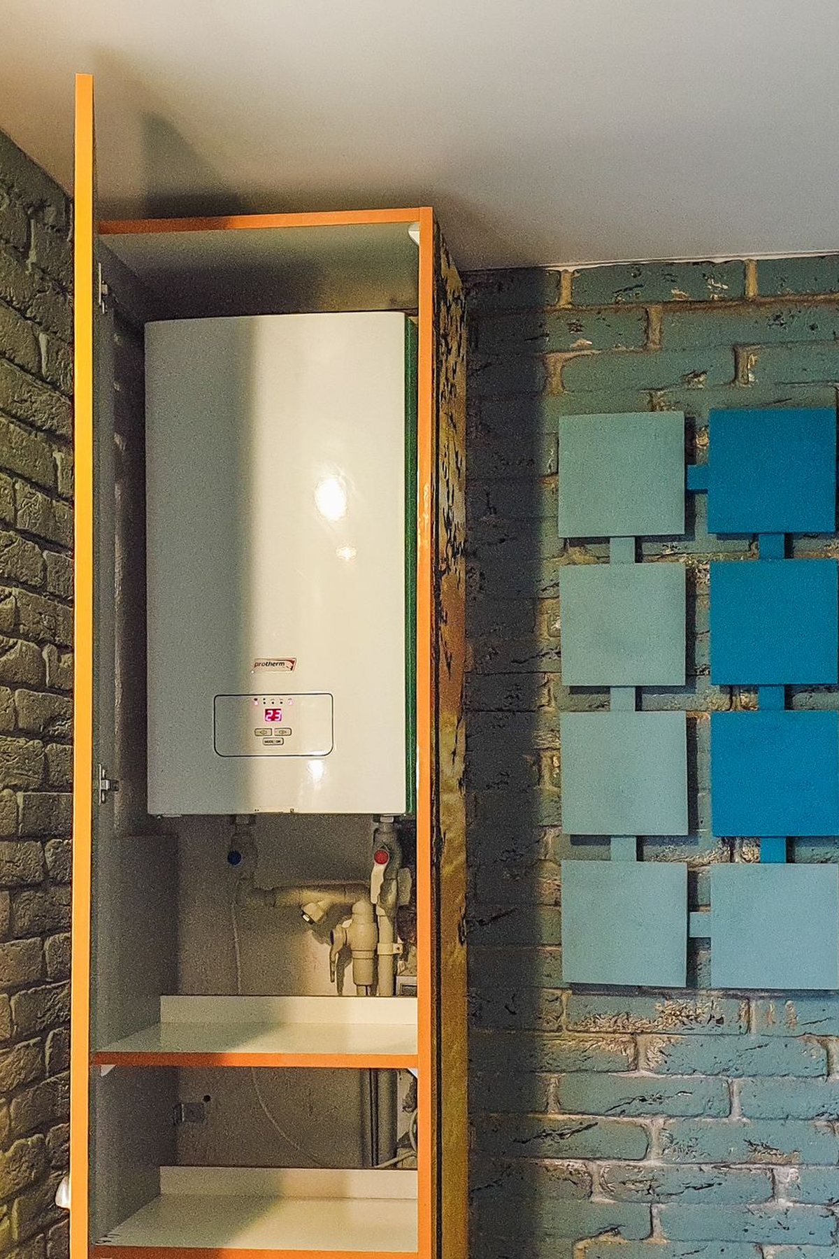 Wall-mounted gas furnace unit installed in a utility closet