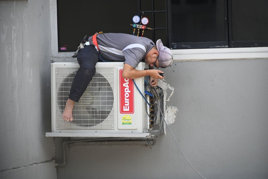 HVAC technician servicing an air conditioning system
